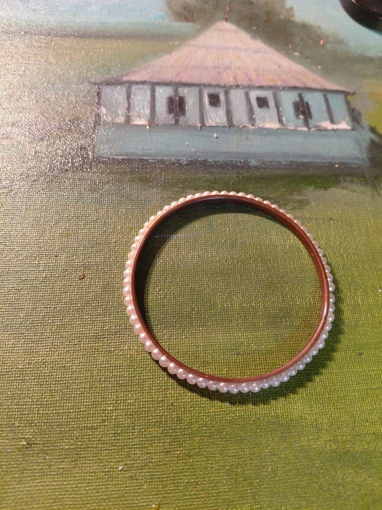 vintage gold-filled or rolled gold bangle bracelet with faux pearls.