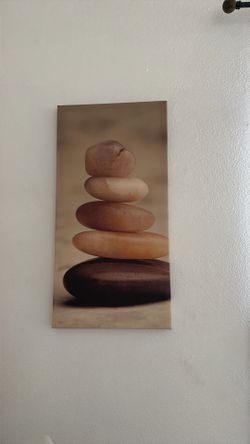 canvas print depicting a stack of smooth, balanced stones in a zen-like arrangement