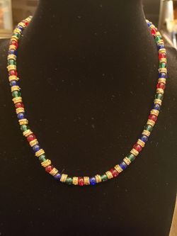 Handmade red, green and blue glass bead necklace with gold a circular charms in between each glass bead. 17 inches. Heavy.