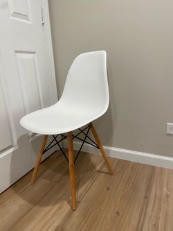 White plastic chair wood base