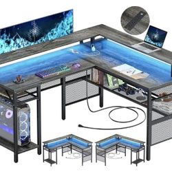 Modern L-shaped gaming desk. LED lights, shelving.