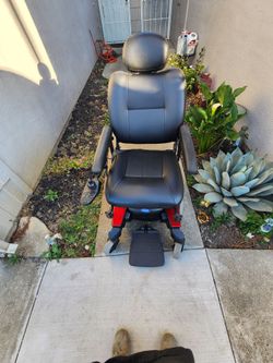 Invacare power wheelchair with a rear vehicle carrier/platform included.