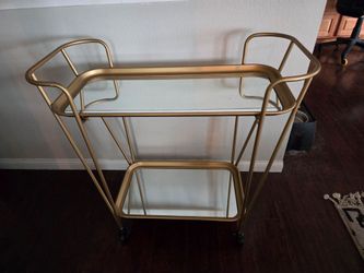Gold bar cart with mirrors.