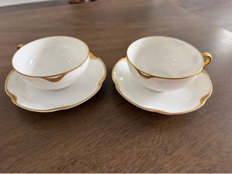 High-quality cups and saucers with elegant gold trim.