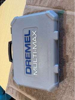 Versatile Dremel Multi-Max MM30 oscillating tool is gray and black. This corded power tool has a hard plastic carrying case. It includes a scraper bla