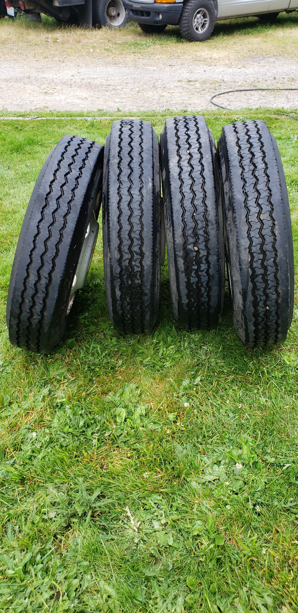 Set of four Bridgestone 225/70 R19.5 truck tires on ten lug steel rims