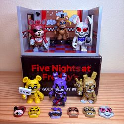 FNAF Figure set Includes Five Nights at Freddy’s Golden Freddy with Stage and several FNAF figures with interchangeable faces and torsos.