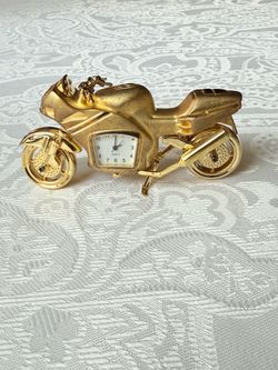 This Collectible Motorcycle theme Mini-Clock is a unique and vintage piece that will make a great addition to any collection. With a gold color and ma