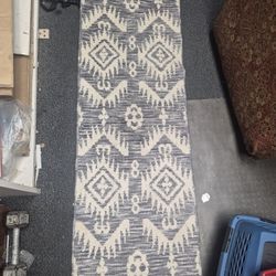 tribal Moroccan-style kilim runner rug, commonly featuring a wool or cotton blend with a high-low textured flatweave. 