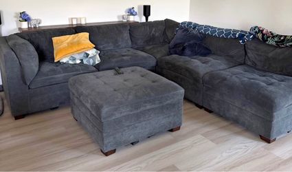 Grey sectional couch with ottoman