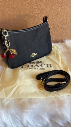 Coach purse with cherry bag charm