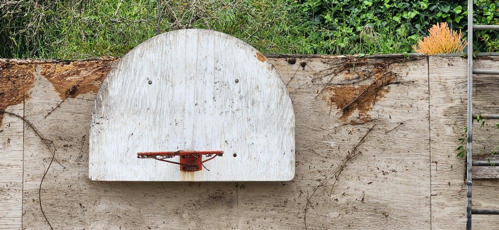 Basketball backboard and hoop with mounting bracket