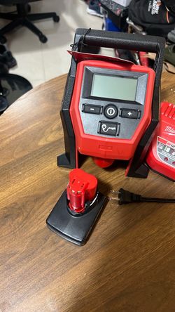 Brand new Milwaukee, inflator charger and battery