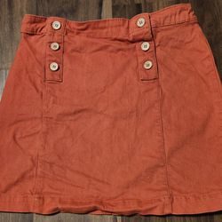 NWOT Copper Key Girls Sz L (10/12) Burnt Orange Denim A Line Skirt with two tabs featuring three buttons each (for decoration only)