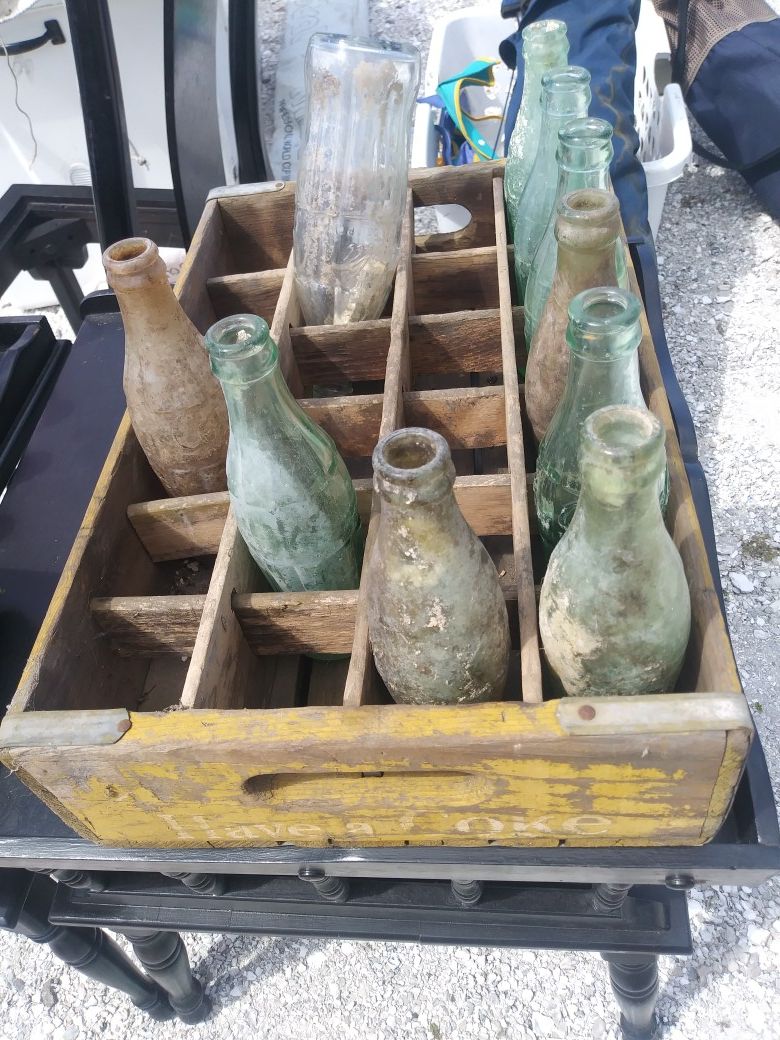 Coke bottles w rack antiques