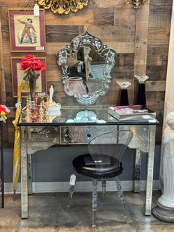 mirrored vanity with mirror and chair