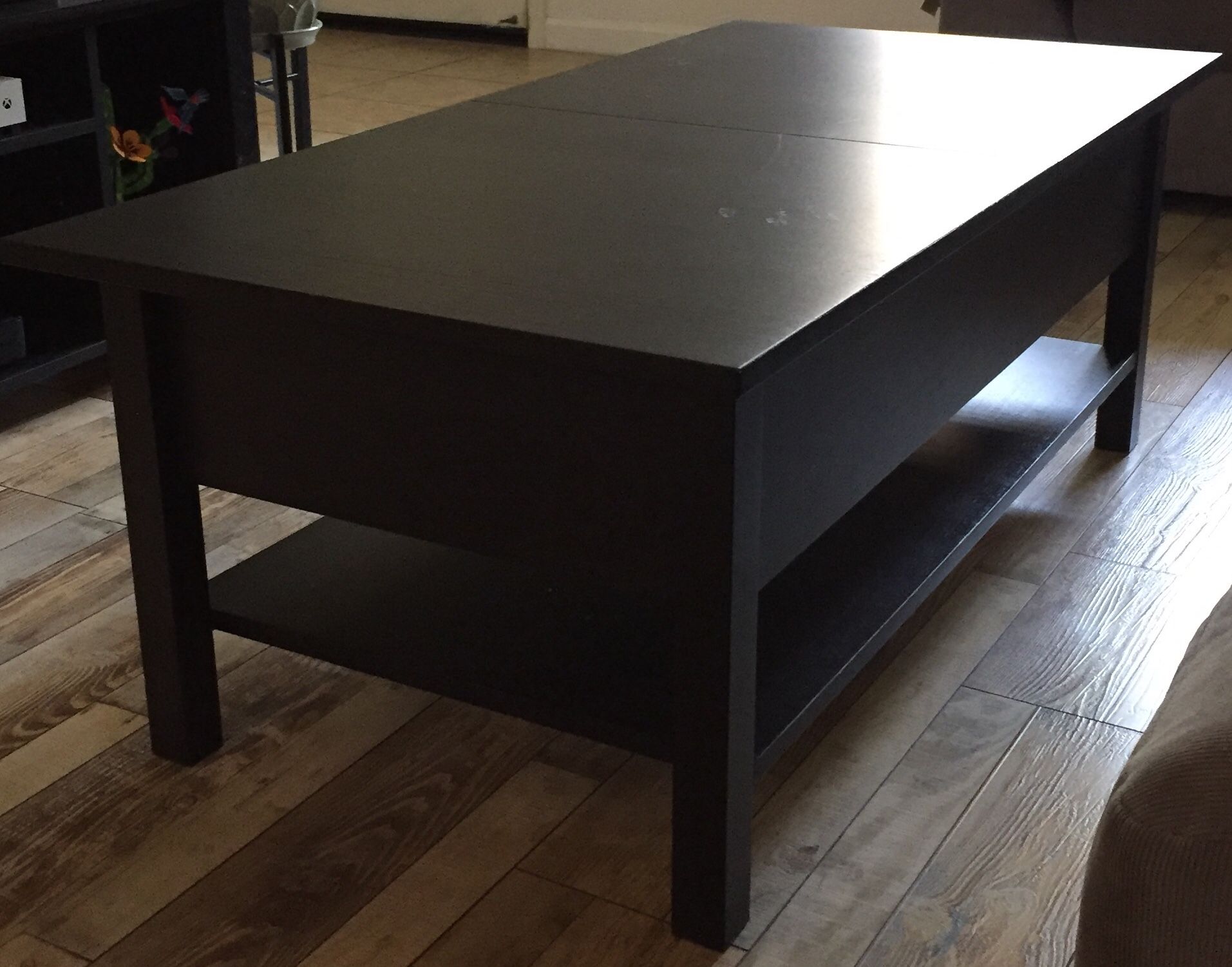 Gently used coffee table with extra leaf and game storage $50