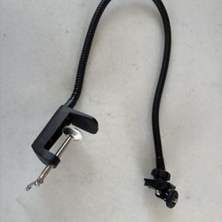  flexible gooseneck arm with a clamp and a 1/4” screw mount for a camera or microphone.