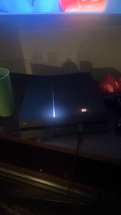PlayStation 4 with 3 controllers,2 controller stands,and multiple game disks
