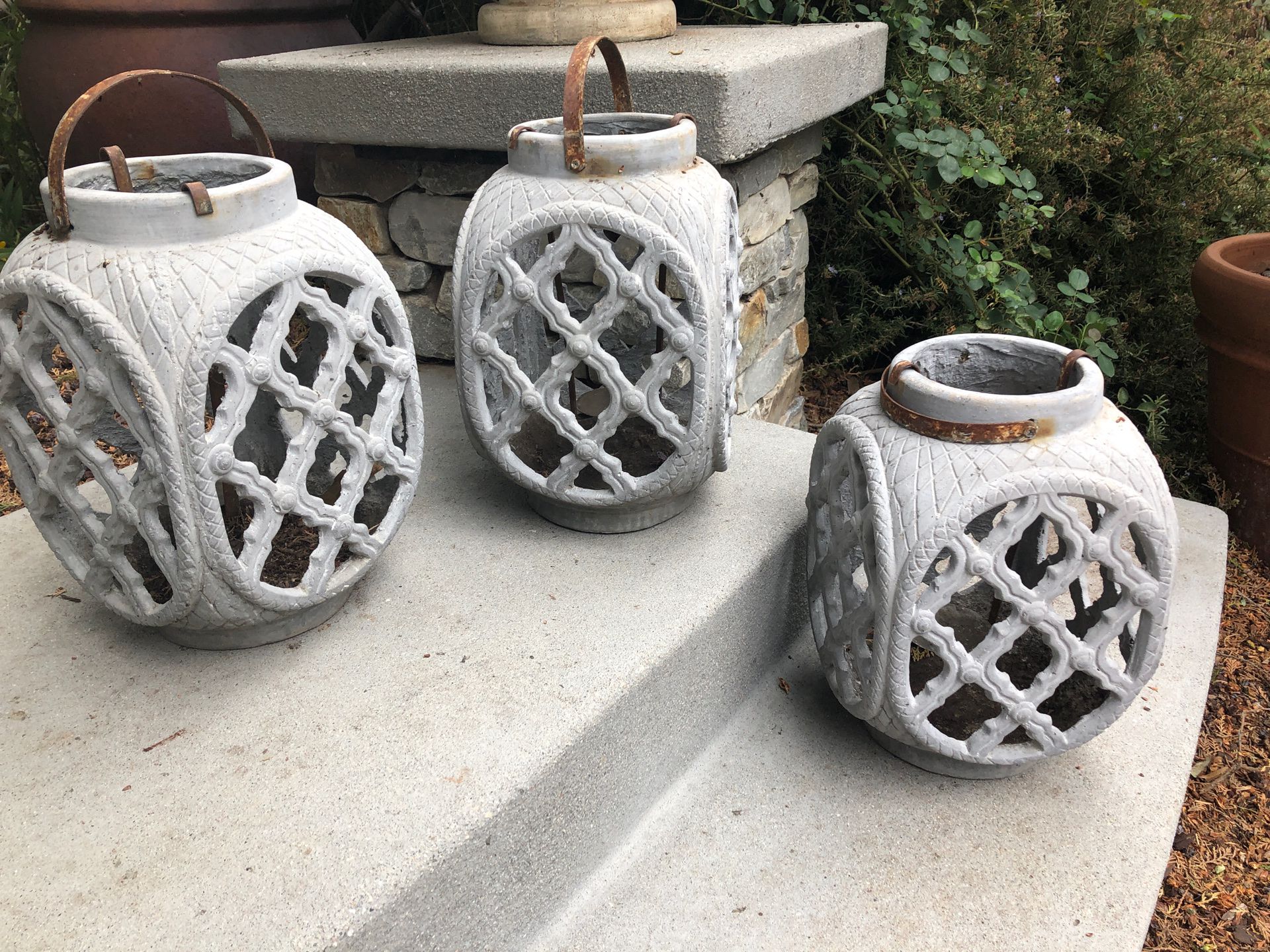 Three outdoor candle holders lanterns