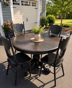 Solid oak Amish table with four carved chairs