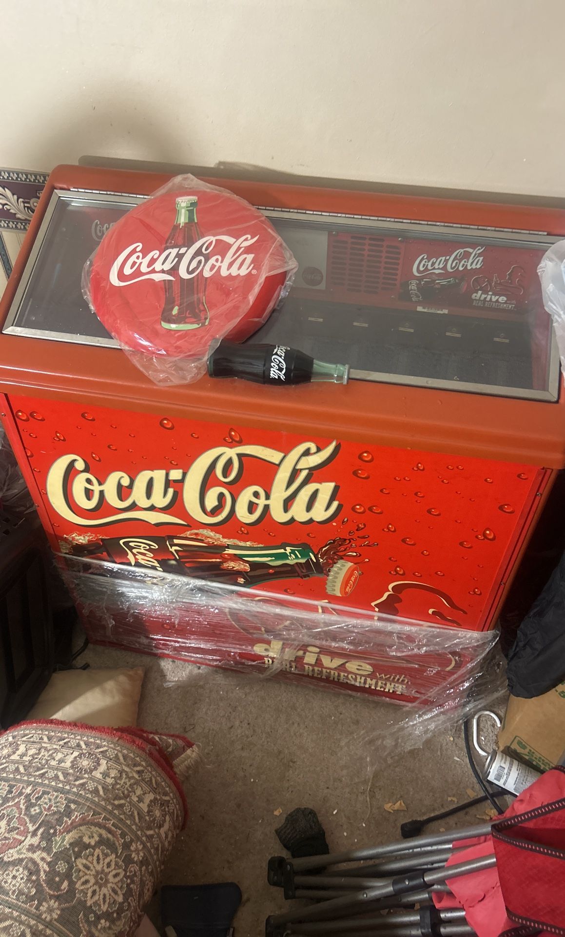 Coca Cola fridge, Model number RPUC100 and Deadstock 2010 Coca-Cola Hallow Curved Tin Button Sign