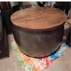 Round metal table with the wooden top opens up for storage