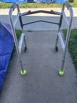 Folding walker with tennis balls