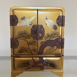 A small gilded lacquered jewel cabinet 