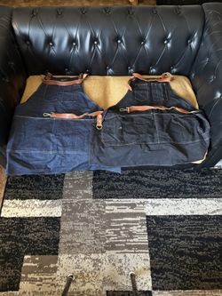 JEAN APRONS WITH LEATHER STRAPS ONE BLACK ONE BLUE GOOD FOR THE BARBECUE $13 EACH