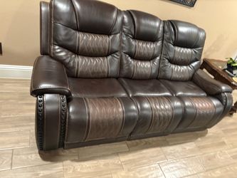 Brown leather couch with manual recliner