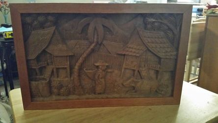 Hand carved village wall hanging