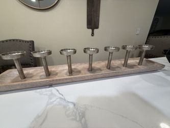 7-branch wooden candle stand, often used as a table centerpiece. 