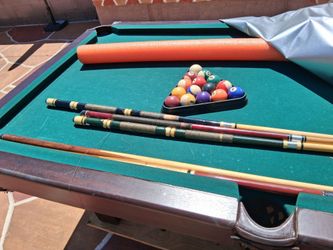 Pool Table with Balls and Cue Sticks