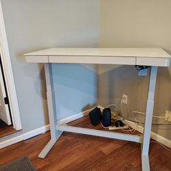 Contemporary height adjustable glass top desk with lots of features in excellent condition.