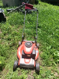 A orange push mower