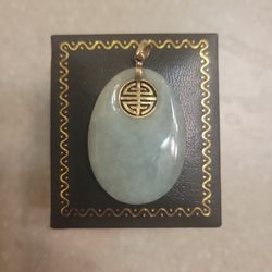 14 K Gold And Jade Pendant.  Weight Is 7.3 Grams