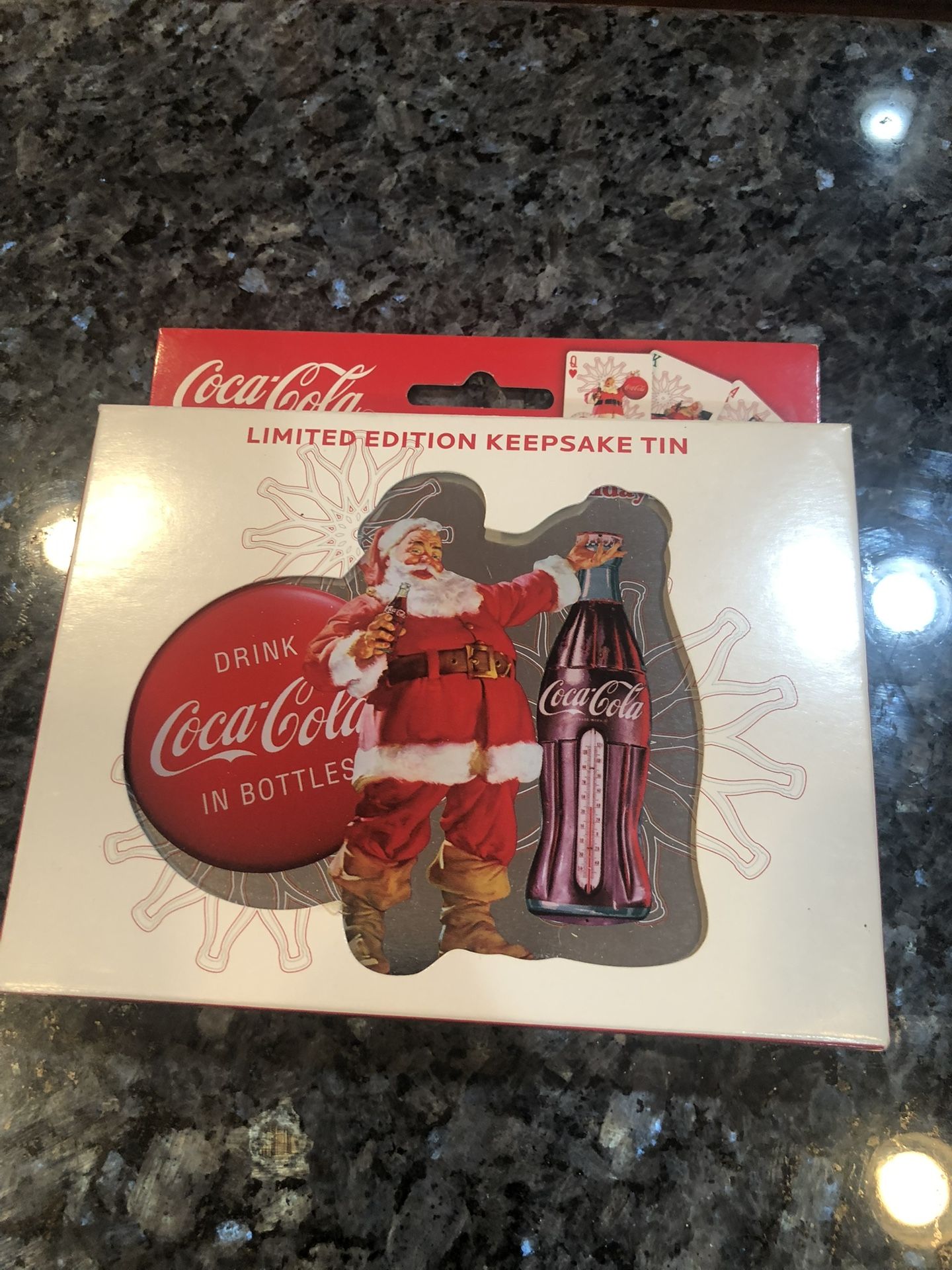 Coca Cola Limited Edition Keepsake Tin with 2 Decks of Playing Cards. The cards are factory sealed. The tin is really cute with a bottle cap ,a coke