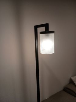 Modern Malva Floor Lamp With The Sleek Rectangular Metal Frame In a Blacken Bronze Finish and Cylindrical Glass Shade H68"