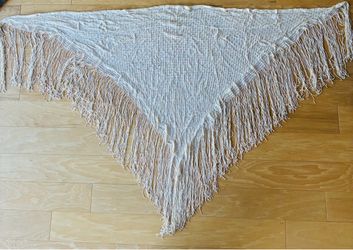 White shawl with long fringe.