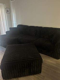 Black plush couch and ottoman