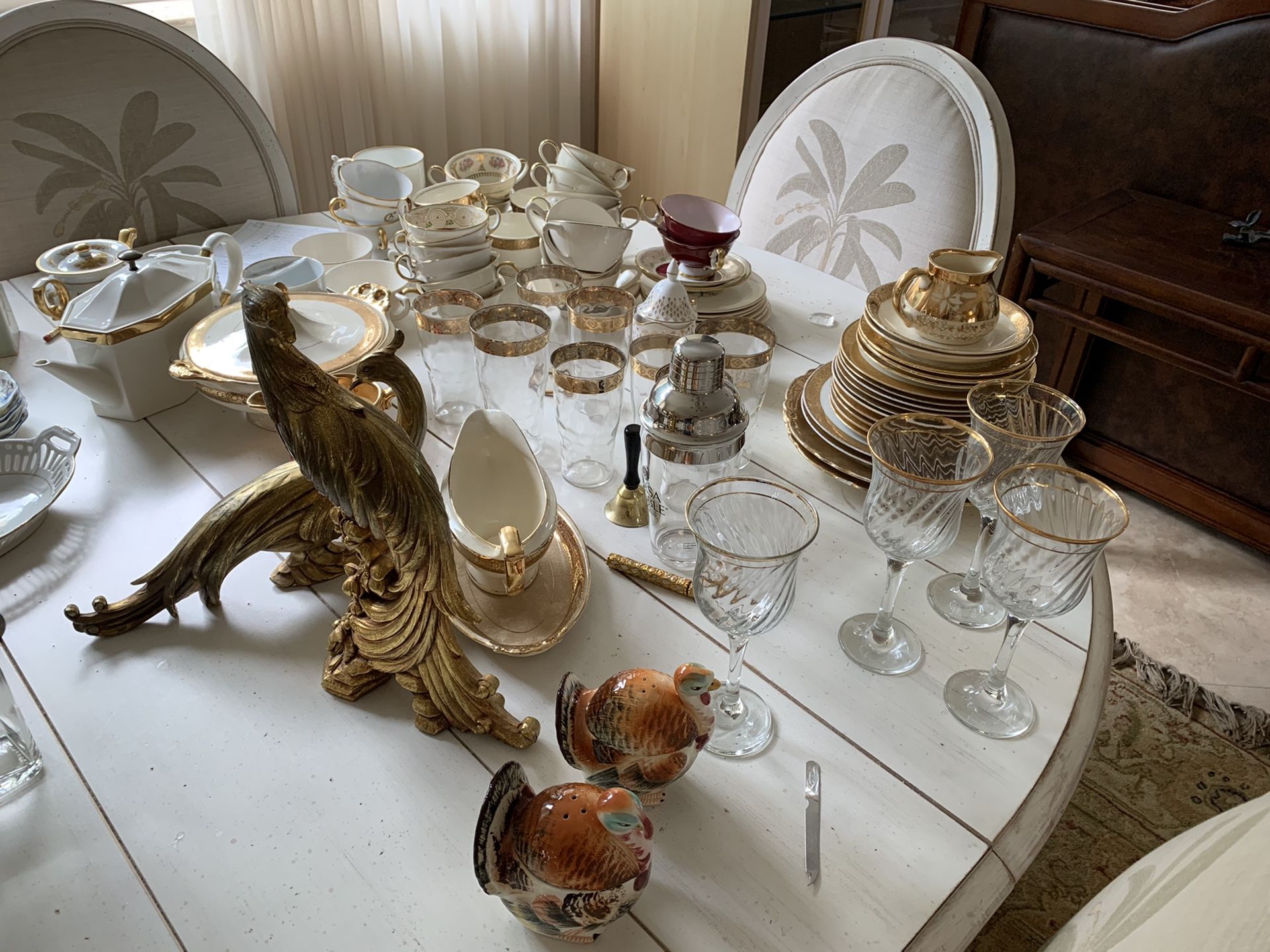 Gold embellished dishes, tea cups, and tall glasses