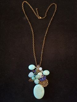 $10. Turquoise rock necklace. Brass tone. 24 inches.