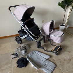 Uppababy Cruz V2 Stroller With Bassinet And Piggyback Board Pink. Comes with rain cover, bug net and insert.