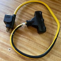 Portable Ground Fault Circuit Interrupter (GFCI) adapter with a triple-tap connecto