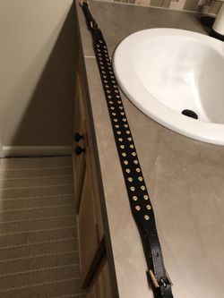 Michael Kors gold studded black leather purse strap.