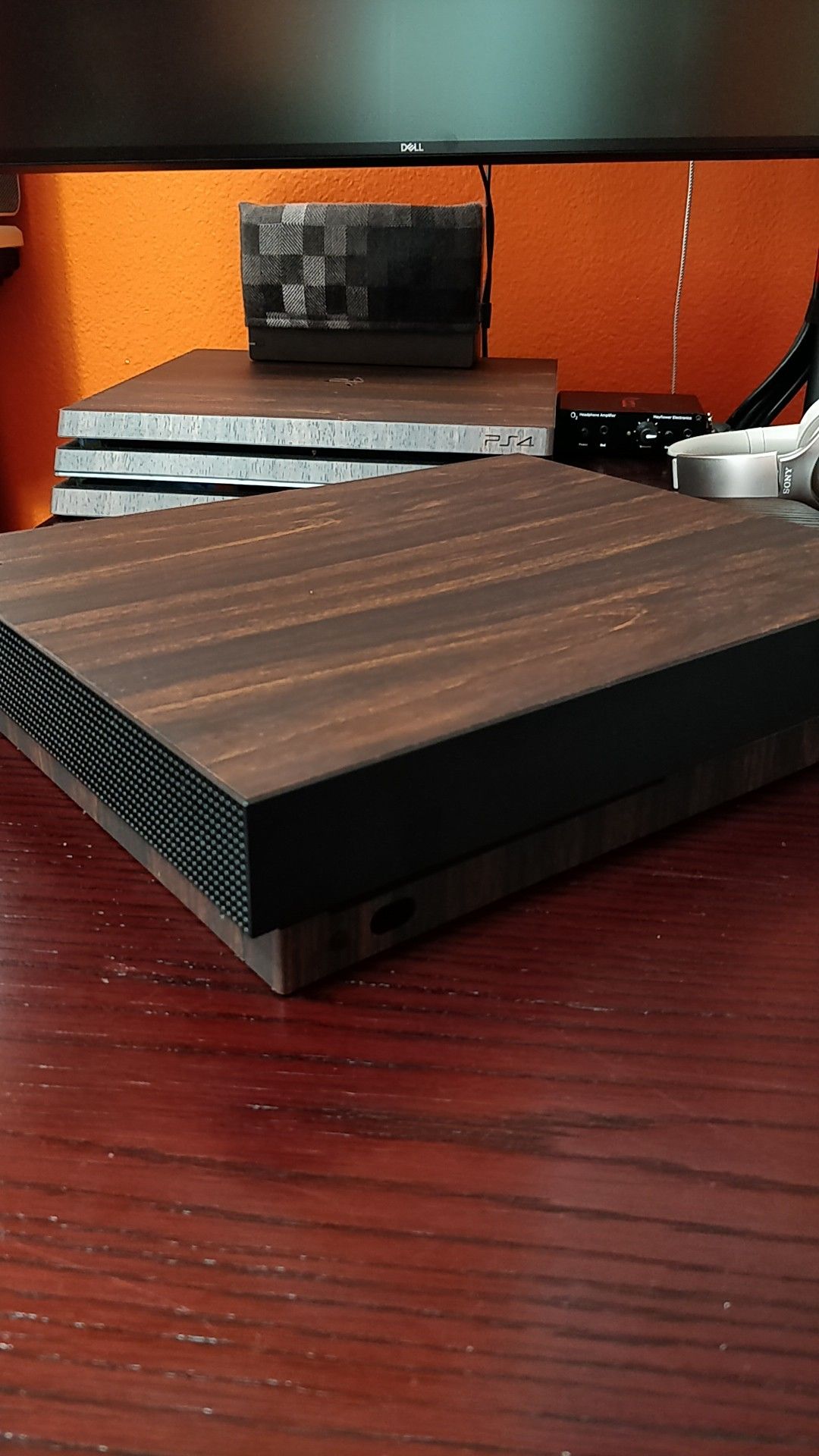 Xbox one X with Dbrand skin.