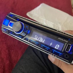 Alpine car stereo, with aux USB and Bluetooth settings.