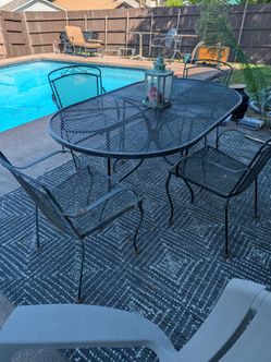 Black outdoor cast iron patio table and chairs