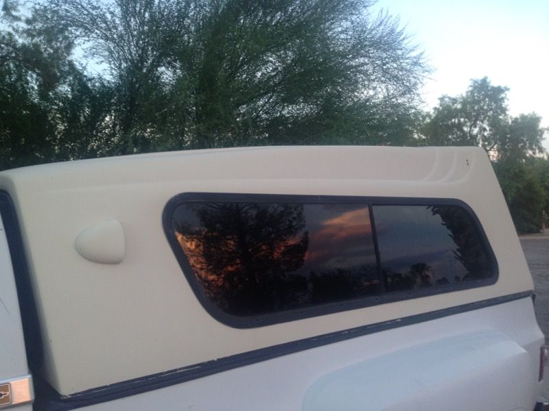 Fiberglass camper shell Nice shape. Tint, all glass good, will include mounting hardware and rubber boot Fits Full size long bed